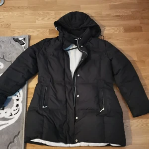 En svart Tommy hilfiger jacka - En jätte fin Tommy jacka den sitter perfekt som storlek L men har själv använt den som storlek M. Perfekt för vintern. Har bara använt 4 gånger 