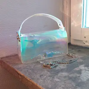 Holographic handväska med avtagbar metall kedja från Zara. Måtten är 19x11x7. Väskan är i bra skick.