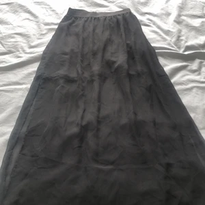 Lång kjol me slits - Kjolen är i storlek 38 men den är insydd vid midjan. Jag är en XS i midjan, men den e stretchig. Kjolen har slitsar på sidorna och under kjolen slutar vid låren och sen blir sen mer ”genomskinlig” 