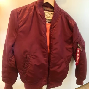 Alpha Industries Ma-1 röd Medium M bomberjacka  - Alpha Industries Ma-1 röd Medium M, perfekt skick! Använd 2 ggr pga fel storlek och det var för sent för att byta det.