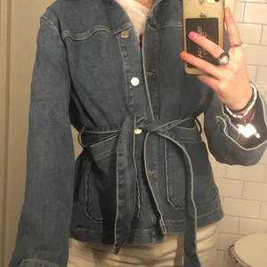 Jeans jacka med skärp  - Jag säljer en jeans blå jeans jacka med ett super fint skärp i midjan till. Man kan välja att ha skärper knytet i midjan men också ta bort det å bara ha en oversized jeans jacka. Jackan är från Carin Wester i storlek 34🥰🥰