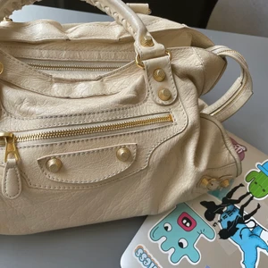  Balenciaga väska💓💓 - INTRESSKOLL PÅ BALENCIAGA VÄSKA! En såååååå fin balenciaga väska i en beige färg med guldiga nitar. Perfekt storlek och perfekt nu till våren. Är ganska slitet som man kan se på sista bilden men de är inget som stör tycker jag då det är på baksidan plus att den ser lite ”vintage” ut vilket är coolt. Dustbag och kvitto finns. INGA BUD UNDER 4000💓💓