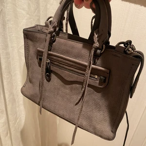 Rebecca minkoff väska - Säljer nu min väska från rebecca minkoff som är i fint sick. Den är grå i ett mocka material. Ny pris ca 3000 även dustbag finns. Köp direkt för 600💗💗