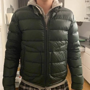 Moncler acourus  -  Säljer min relativt nya Moncler acorus som är i storlek 4 (L). Jacka är köpt på kaspersheat vid årsskiftet och är bara använd ett par gånger. Denna gröna färgen är sällsynt i de flesta modellerna för moncler. Säljer pågrund av inte riktigt min typ av jacka. Skicket på jackan skulle jag säga är 8-9/10. Nypris på jackan är ca 8500kr. Priset är inte hugget i sten!