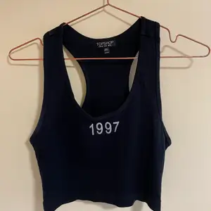 Söt topp med tryck fram där det står ”1997” i glitter. Köpt från Topshop. Passar en storlek S/M. Oanvänd.