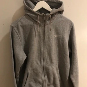 Grå Nike zip hoodie - Säljer denna zip hoodien från Nike den är vintage och snygg men säljer för får inte användning av den! Ni får buda ifrån 100!!