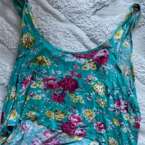 Blommigt linne - Blommigt kortare linne från Forever 21. Storlekslappen är avklippt men skulle säga att den är som en M-L.