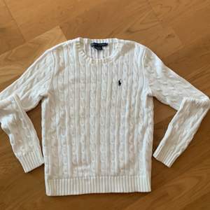 En vit stickad Ralph Lauren tröja i storlek M. Märket är mörkblått. Inga synliga fläckar eller missfärgningar. 