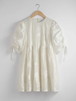Vit kort klänning med broderad design och puffärm från & Other Stories - Supersöt vit klänning med broderade detaljer från & Other Stories! Klänningen har rund halsringning, puffiga trekvartsärmar med knytband och en babydoll-passform💞💞Perfekt till studenten eller sommaren! Aldrig använt och i nyskick med prislapp. Nypris 1390 kr💞💞