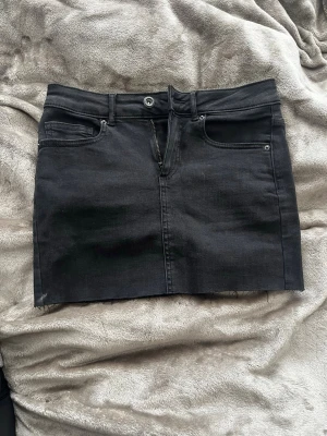 Svart jeanskjol  - Säljer min svarta jeans kjol, knap andvänd pågrund av att den är köpt i fel storlek. Kontakta vid frågor!💕