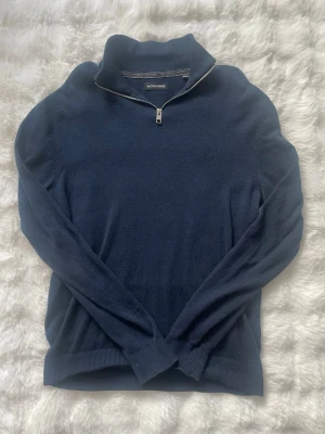 Mörkblå halvzip tröja Jack & Jones med frifrakt - Mörkblå stickad tröja från Jack & Jones med halvzip och hög krage. Knappt använd skick 9/10. Storlek S pris 109kr