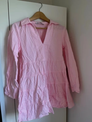 ROSA SOMMARKLÄNNING - Säljer denna fina klänning från Zara. V-ringad och en kortare ärm, perfekt för sommarkvällar! Klänningen har använts några gånger, men är fortfarande i mycket bra skick. Säljer då den tyvärr blivit för liten för mig. 
