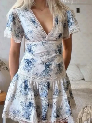 Guess klänning - Säljer en superfin och trendig klänning från Guess i storlek XS. Klänningen är i mycket gott skick och använd endast ett fåtal gånger. Den har ett romantiskt blommönster i blått och vitt samt fina spetsdetaljer som ger en feminin och elegant look.💓  Perfekt för sommaren, studentfester, middagar eller andra tillfällen där du vill känna dig extra fin. En populär och eftertraktad modell som passar perfekt till säsongens trender.Jag är öppen för bud och om ni har några frågor är det bara att fråga 😊