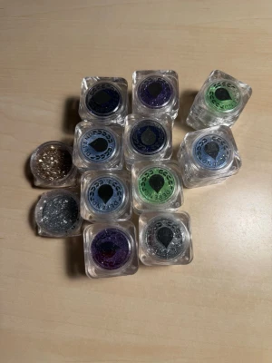 Dipend nagelglitter i olika färger - Säljer flera burkar nagelglitter från Dipend i olika färger som mörkblå, lila, grön och ljusblå, guld, silver. Perfekt för att skapa kreativa och glittriga nageldesigner. Kommer i små genomskinliga burkar med skruvlock. Dem är oöppnade! 