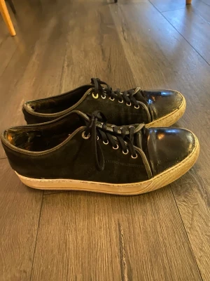 Svarta lanvins med glans  - Säljer ett par svarta lanvins med glans, de är i okej skick men slitna vid ankeln (se sista bild) därav priset. Storlek 42 (UK 6) men passar större då uk storlekar är stora i storlek så passar bättre 43/44. Skriv vid minsta lilla intresse. Endast skor ingår 