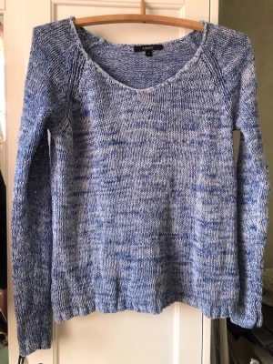 Blåmelerad stickad tröja från LINDEX - Stickad tröja i en så vacker blåmelerad nyans. LINDEX med rund halsringning och långa ärmar. Tröjan är tillverkad i 70% bomull och 30% polyamid, vilket gör den både mjuk och lätt. Snygg till jeans.