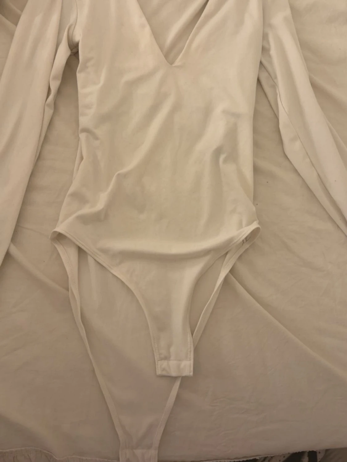 Vit långärmad body från H&M