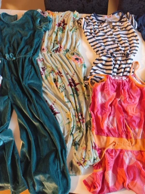 Färgglada jumpsuits i olika mönster stl 122/128 - Säljer ett gäng jumpsuits i olika färger och mönster – bland annat en grön ribbad, en blommig i pastell, en randig i blått och vitt, en rosa-orange med grafiskt mönster och en gul med blommor. Alla har resår i midjan och är i mjuka material, perfekta för chill dagar.  Du är varmt välkommen att kika på mina andra annonser. Sammanfrakt 