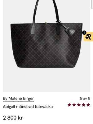  By Malene Birger väska  - Stilren toteväska från By Malene Birger i svart med brunt grafiskt mönster. Använd men fint skick. Pris 1500 kr. 