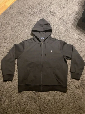 Svart polo Ralph lauren tracksuit  - Säljer denna feta polo Ralph lauren tracksuiten då den ej passar. Skick 10/10 ej använd. Koftan är i storlek XL men passar mer som L och byxorna är i storlek XL. Säljer även denna separat så om du är intresserad skriv gärna. Pris går att diskutera 