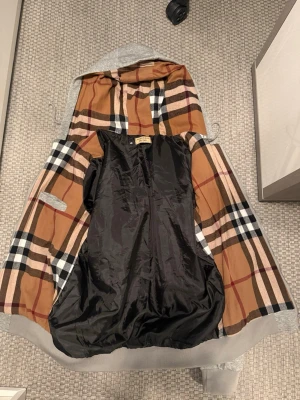 Grå Burberry zipper tröja. - Grå riktigt skön och stilig Burberry tröja, enkel zipper och bra passform. Ny liknande skick och inga fel någonstans. Storlek är större an vad det står på tröjan och passar bättre för storlek M. Hör gärna av vid frågor eller snabba affärer.👌🏽