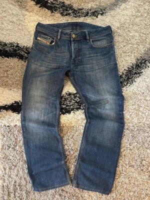 Diesel Bootcut Jeans - Säljer ett par Skitsnygga diesel Straight/bootcut Jeans. Perfekta för kommande väder och går att matcha med nästan vad som helst! vid flera funderingar hör av er.  Storlek: W33 L32  Laid out liggandes (Mått) Midja: 42,5 cm Langd: 99 cm Nedre bredd (Vid benslutet): 21 cm  Kondition: 8,5/10✅  Fraktar samma eller dagen efter✌🏻❤️  swag rap streetwear baggy vintage skate hiphop y 2k affliction archive underground avant garde japan style OG 2000s flared washed affliction jeans drip oldmoney denim grisch