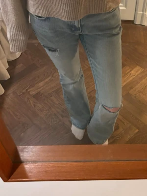 Lösare flare jeans med hål - Säljer ett par flare jeans med lösare passform! Jeansen är i en en jättefin ljusblå färg. Medellåg midja. För referens så är jag 172cm och har 36 i jeans eller 27/34 beroende på hur jeansen är mätta!❤️ hör av er vid frågor eller om nån vill ha fler bilder osv.🩷🩷