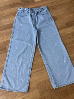 Jeans med broderade rosetter från Friful  - Jeans med broderade rosetter från Friful 💙 Byxorna är märkta L, Vida ben och superfin ljusblå färg. I mycket fint skick ✨