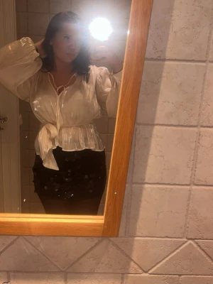 Fin vit glansig blus från Gina  - Säljer en vit glansig blus med långa, vida ärmar och knytband i midjan. Perfekt till fest tillfällen men går även att klä ner och ha till vardags. Den har inga defekter och ser ny ut. Fråga gärna om ni vill ha mer bilder eller om ni undrar något annat❤️