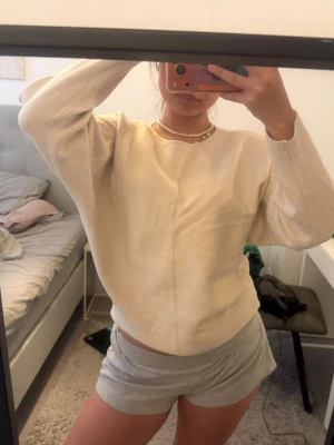 Beige sweatshirt med rund hals - Enkel och stilren beige sweatshirt med rund halsringning och långa ärmar. Tröjan har en rak passform och mjukt material som känns skönt mot huden. Perfekt för en avslappnad look.