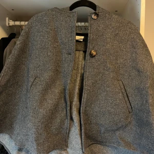 Cape/kappa/poncho  - Grå cape/kappa/poncho med hål för armarna från Zara barn. Storlek 13/14 years men skulle säga att den passar XS. Fint skick 