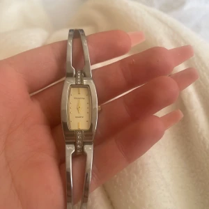 Silver mini klocka  - Stainless Steel back och tror den är silver pläterad där fram, quartz finns i den också. Säljer jättebilligt för behöver pengar just nu. 