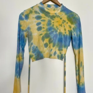 Unik croptop i storlek S  - Cool croppad topp med band som går att knyta som man vill. Skönt elastiskt material. Mycket fint skick, inga skavanker! Okänt varumärke utan angiven storlek, men passar XS-S 🌸