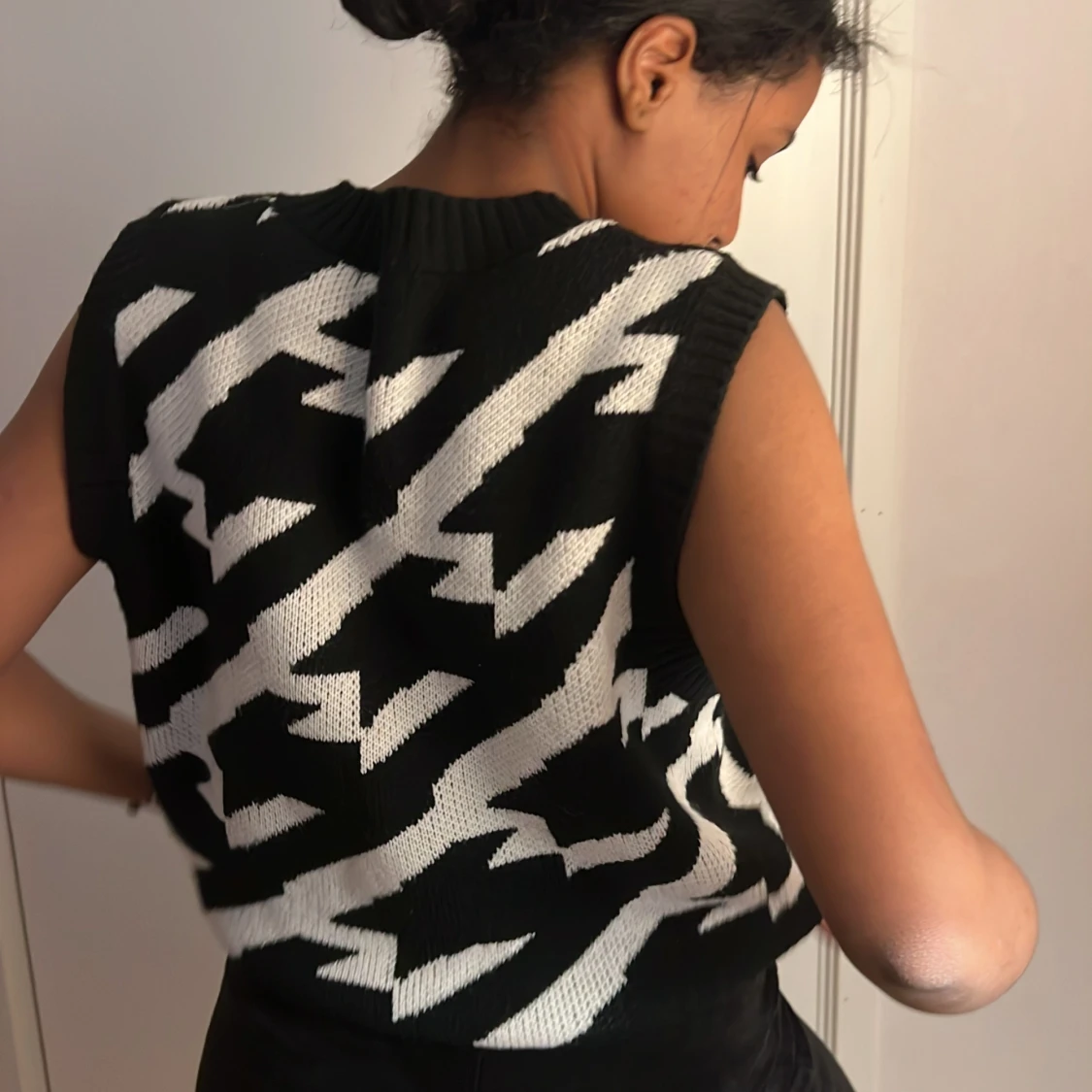 En stickad tröja som är randig svart och vit  - 90