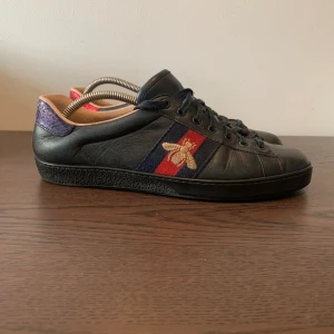 Gucci ace - Helsvarta Gucci ace bee i bra skick utom creasning här och där (skick 8.25/10). Storlek 44 sitter lite litet i storlek passar också 43-43.5. Vid köp ingår originalpresentsnöre. Skorna ser nästan skrögliga ut men i verkligheten ser dem fräschare ut. 
