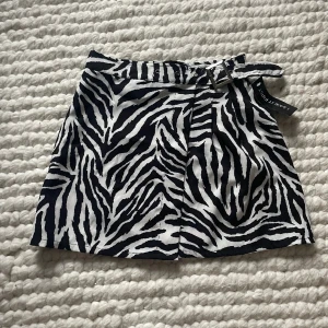 Kort zebrakjol - Snygg omlott kjol💓 Går att justera bältet hur man själv vill ha det!  Lappen är kvar så endast testad 