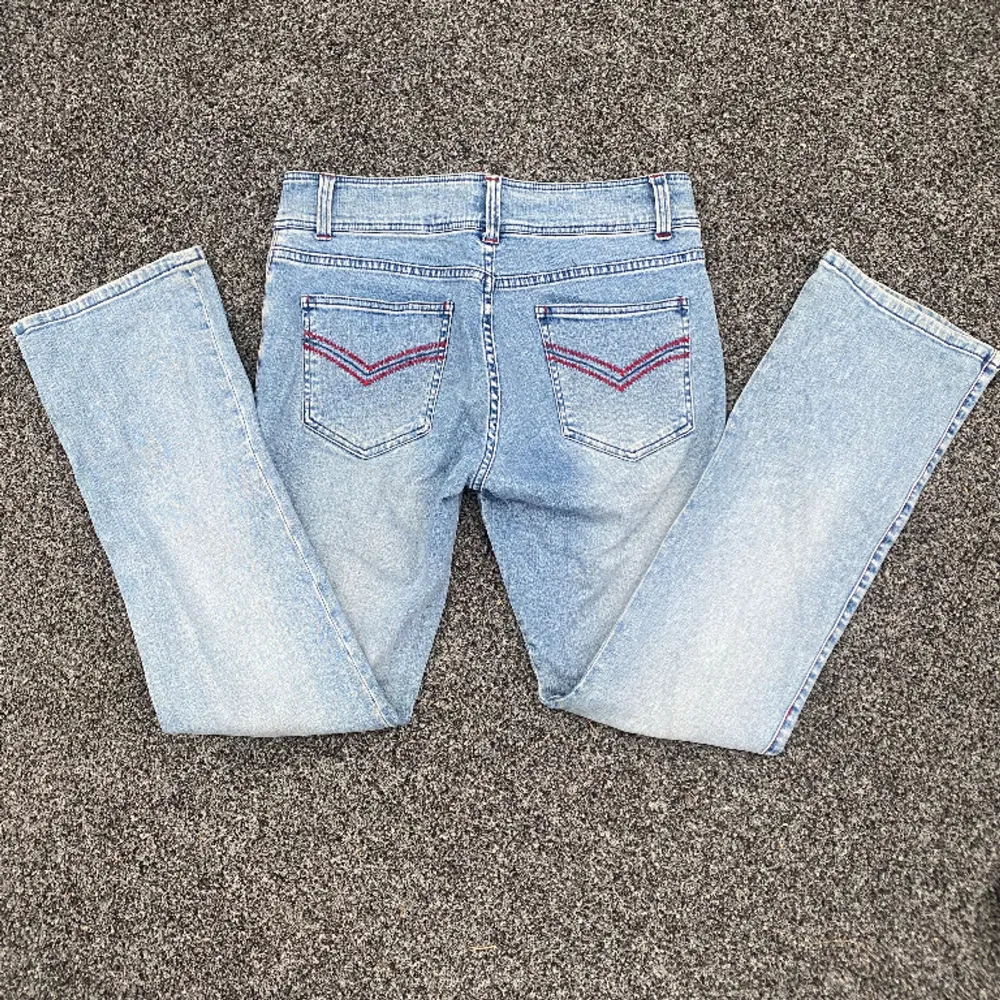 Jätte fina lågmidjade jeans med coola röda detaljer och en snygg ficka vid en av knäna. Beställde hem dessa vintage men de var tyvärr för stora därav säljer jag de vidare❤️ (Startpris 250 kr och om fler är intresserade blir de budgivning). Jeans & Byxor.