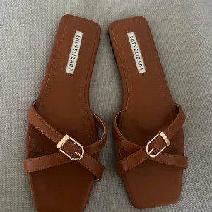 Slip-in sandal med spänne - Helt ny och oanvända bruna slip-ins med guldigt spänne