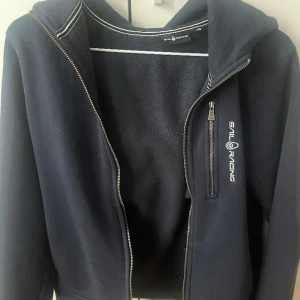 Sail Racing - Sail Racing zip up tröja, jätte bra skick. Köpt på KidsBrandStore nypris 999kr. Storlek 170 - Xs/S