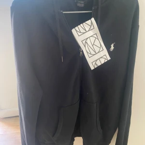 Polo hoodie - Säljer min polo hoodie då jag knappt använder den pga att den är för stor för mig. Köpt 2023 på Nk för 1890 kr och har sen dess används sparsamt, kvitto medföljer.  Kan gå ner i pris vid snabb affär