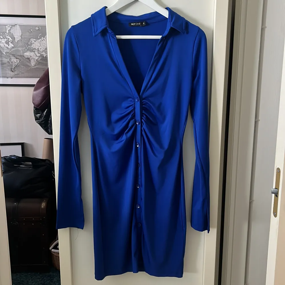 Marinblå långärmad button down klänning från NLYONE i storlek S. Igensydd längst ned för att det var väldigt öppet. Stygnen syns ej när klänningen är på. Mekot.