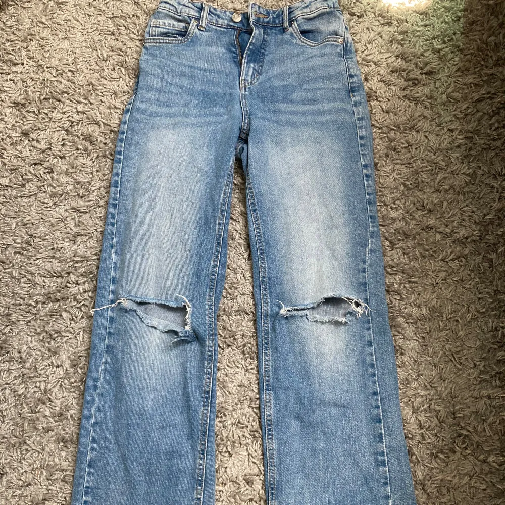 Jeans med hål på knäna från Kappahl i storlek 164 men passar mig som brukar ha 32 köptes för 2 år sedan använda men i ny skick!. Jeans & Byxor.