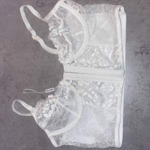 White corset is from Nelly that they don’t sell anymore from the lingerie section, with lace detailing. It’s more on the small body side. Not used.  Size - XS / 34 (only mentions cup size on website) Cup size - 70B