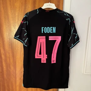 City tredjeställ 23/24 Foden 47 - Tröjan är helt oanvänd med etikett kvar. Manchester city tredjeställ med Foden 47 på ryggen från säsongen 23/24 där han vann player of the season. Perfekt för sommaren och det pågående EM mästerskapet i Tyskland