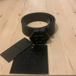 Äkta Philip plain bälte  - Säljer ett Philip plain bälte (äkta) det är äkta och helt nytt bara testat modellen är hexagon matte black storlek 70