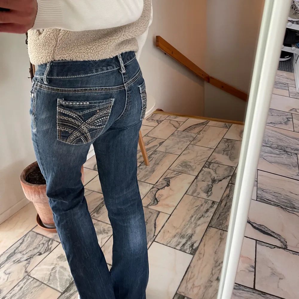 Jeans från Urban outfiters med snygga detaljer på fickorna. I fint skick förutom att de har en liten reva på framsidan av låret (se bild två).De är lågmidjade och passar en S/M. Jeans & Byxor.