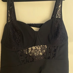 Corssett - Svart korsett från HM med spetsdetaljer och öppen rygg. Även dold dragkedja på sidan. Oanvänd, endast provat den. 