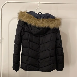 Jacka - Svart täckjacka med pälsluva. Köpt på intersport. Oanvänd!