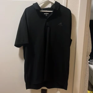 Golfpike  - En svart adidas golftröja. Använd typ 3ggr