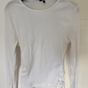 Vit tröja  - Vit ribbad tröja med justerbara snören på båda sidorna🤍 Från Pieces i storlek M🤍 Aldrig använd!